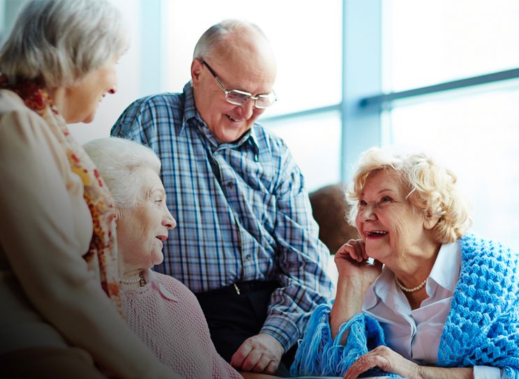 group of seniors laughing- Assisted Living & Memory Care